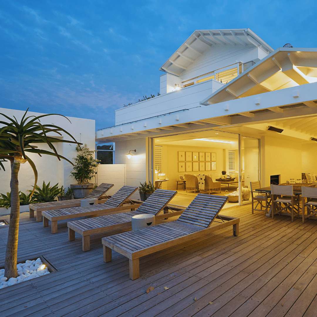 Premium timber deck with outdoor loungers and indoor-outdoor flow at an Auckland home, built by Yourtradie.